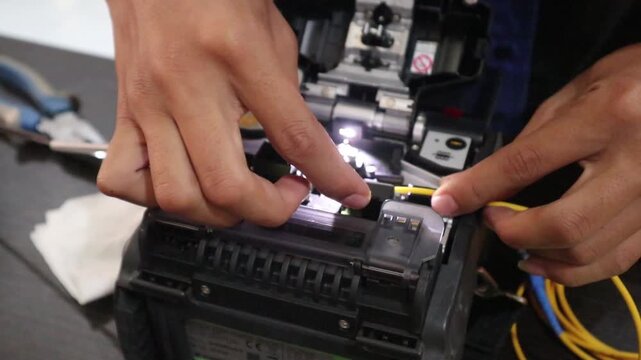 Technicians connecting fiber optic cables for the internet network.