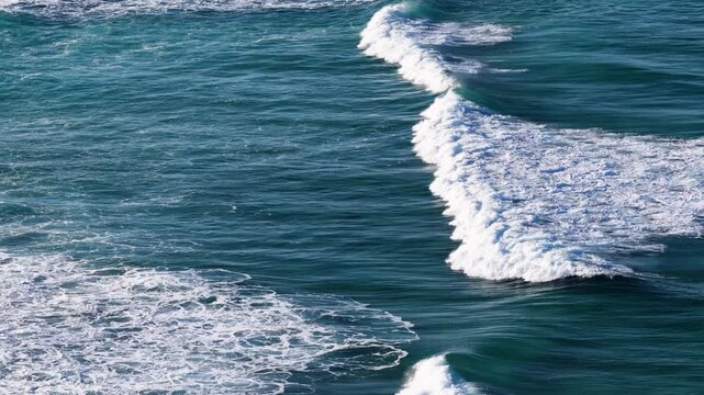Ocean Waves Breaking with White Foam in Blue Sea