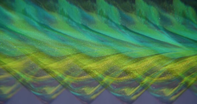 Defocused glitter flow. Sparkling paint. Yellow blue purple colorful fluid shiny texture floating on abstract art neon background.