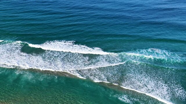 Aerial View of Ocean Waves Breaking Over Shallow Sandbar