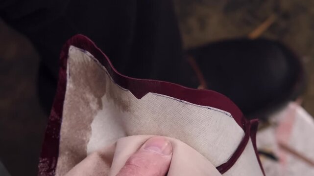 Cobbler service. Leather workshop. Unrecognizable shoe master man hands applying glue with brush for professional manufacturing.