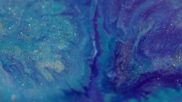 Shimmering fluid art. Shiny texture defocused. Purple blue particles liquid explosion on sparkling glow paint color abstract background.