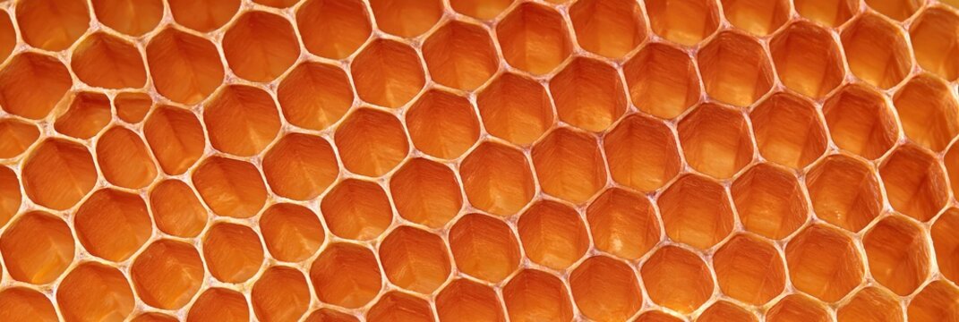 Macro close up of golden beeswax honeycomb structure with intricate geometric cells