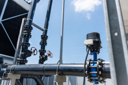 Industrial pipeline and automated control valve system at cooling tower facility outdoors