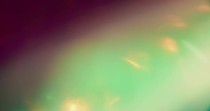 Bokeh glimmer. Gradient light. Defocused blue purple green color flare radiant illuminated flash on abstract optical art background.