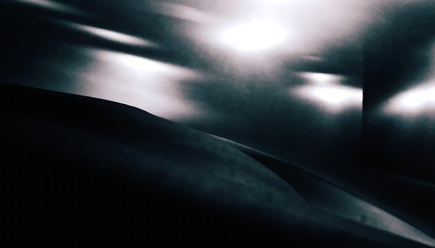 Darkroom inspired abstract photograph with deep black tones and soft glowing light