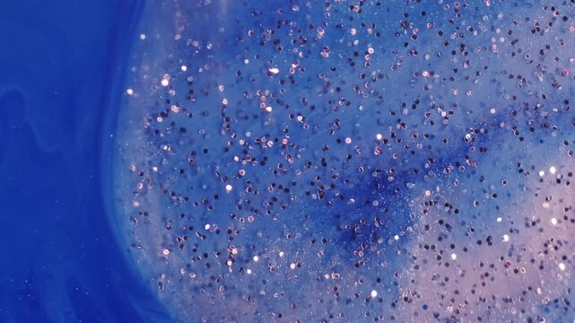 Glitter paint liquid. Marble ink. Defocused blue color water vivid wave round sequins sparkling texture floating on abstract acrylic art background.