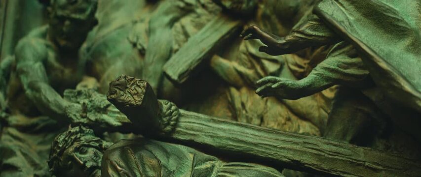 Close-up of bronze crucifixion scene on Duomo di Milano Cathedral door in Italy