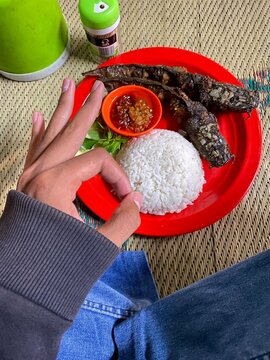 Pecel Lele, Traditional Indonesian Fried Catfish Dish with Rice, Sambal Chili, and Fresh Vegetables