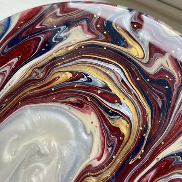 Abstract fluid art with red white blue and gold swirls