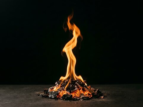 Burning wood charcoal fire on dark stone surface with burning coal