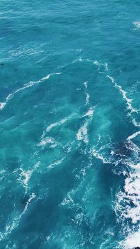Aerial Top Down View of Turquoise Ocean Waves and Sea Foam