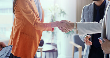 Meeting, greeting and agreement with handshake for business partnership or hiring in office. Group, employees or colleagues shaking hands with deal for job recruiting or career onboarding together © peopleimages.com