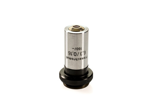 Planachromat 6.3x/0.16 microscope objective marked 160/-, with a silver metal barrel, black mount and threaded base, isolated on a white background.