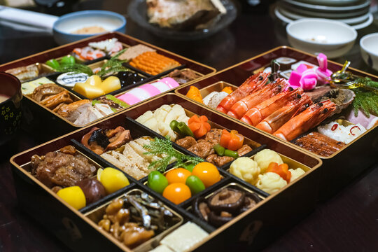 Traditional Japanese New Year Food Osechi Ryori Served in Lacquered Tiered Boxes on Dining Table