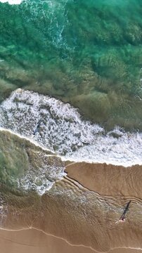 Aerial Top Down View of Person Walking on Sandy Ocean Shoreline