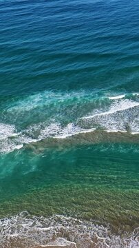 Aerial Overhead View of Turquoise Ocean Waves Crashing on Sand