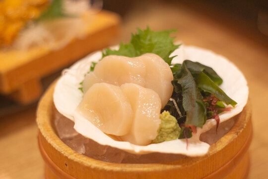 Top down view of a plate of scallop sashimi - Japanese cuisine. Kumamoto, Kyushu, Japan
