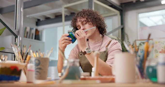 Pottery, design or man in workshop with painting, clay creation or color process in creative hobby. Decoration, pattern and artist with paintbrush, art project or ceramic craft in handcraft activity.