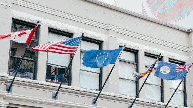 International Flags Waving Outside Modern City Office Building Windows
