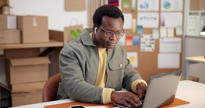 Laptop, music and typing with black man in office for design, planning or project management. Computer, earphones and steaming with happy designer in creative workplace for online report and dance