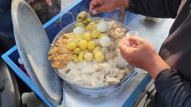 Customer Choosing Indonesian Siomay at a Traditional Street Food Stall