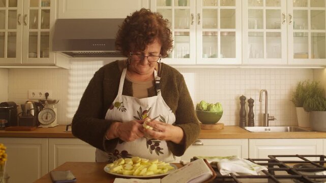 Woman slices a fresh apple as the camera pulls back through a bright kitchen