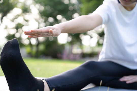 health care female exert on the park. Asian woman doing exercises in morning. balance, recreation, relaxation, calm, good health, happy, relax, healthy lifestyle, reduce stress, peaceful, Attitude.