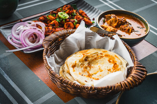 Kerala paratha with chicken curry and prawn roast