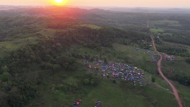 Aerial Sunset View of Rally 2026 Camping Area in Nueva Alborada Paraguay with Tents and Dirt Roads