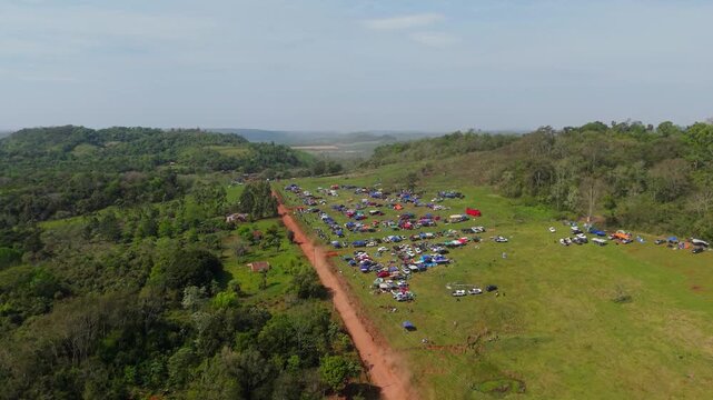 Aerial Drone View of Rally 2026 Event Site in Nueva Alborada Paraguay with Crowds Cars and Dirt Road