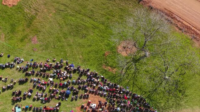 Aerial Top Down View of Rally Fans Beside Rural Dirt Racing Track at Outdoor Motorsport Event