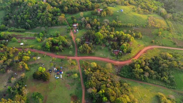 Aerial Top Down View of Winding Dirt Rally Tracks Through Green Rural Countryside Landscape