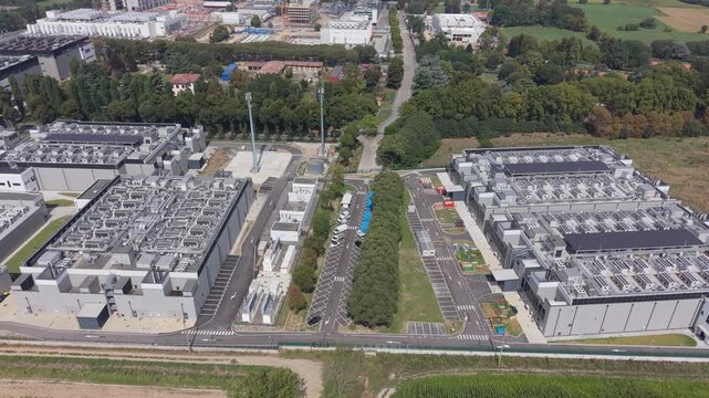 Aerial view of a substantial industrial data center DATA4 facility, with separate buildings, internal roads and visible utility infrastructure.