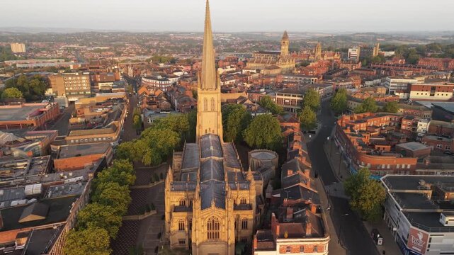 Aerial view of Wakefield, a cathedral city located on the River Calder in West Yorkshire, England, United Kingdom. Drone POV of Wakefield Cathedral  and city centre in early mornings sunrise.