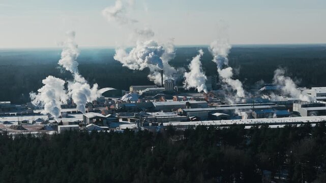 Industrial steam rises over snowy plant, framing carbon pricing and ETS debates