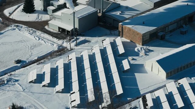 Steam rises over winter sawmill as solar arrays frame decarbonization challenge