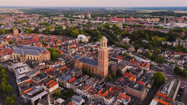 Golden-hour aerial of Zwolle, Netherlands, showing the Peperbus, Grote Kerk and Museum de Fundatie amid dense historic rooftops, tree-lined streets and the old city center.