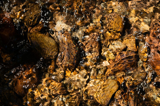 Clear Water Flowing Over River Rocks