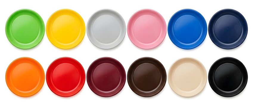 Colorful plastic plates arranged in two rows. Multi-colored round kitchenware dishes isolated on a white background, top view flat lay composition for dining mockups.