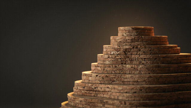 A pyramid stack of circular wooden slices with bark edges arranged in descending size on a dark grey background surface