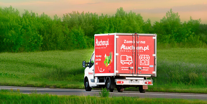 Auchan food delivery truck near warehouse landscape 29.08.2025 Poland, Europe