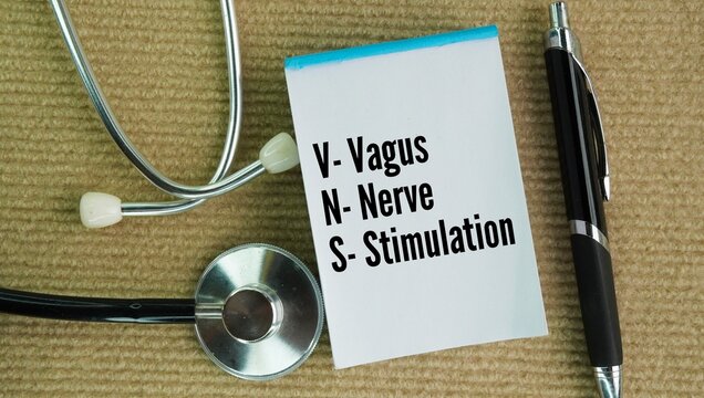 Stethoscope and paper with the word vagus nerve stimulation. medical treatment that delivers mild electrical impulses to the vagus nerve to alter brain activity and treat specific chronic conditions