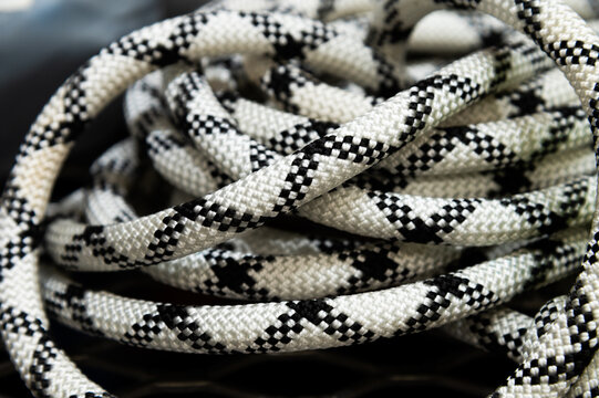 Coiled white and black climbing rope close-up