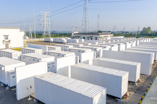 rows of white energy storage battery containers in outdoor facility