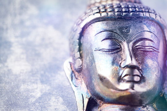 Buddha head on rustic wooden background. Soft focus. Top view. Copy space.