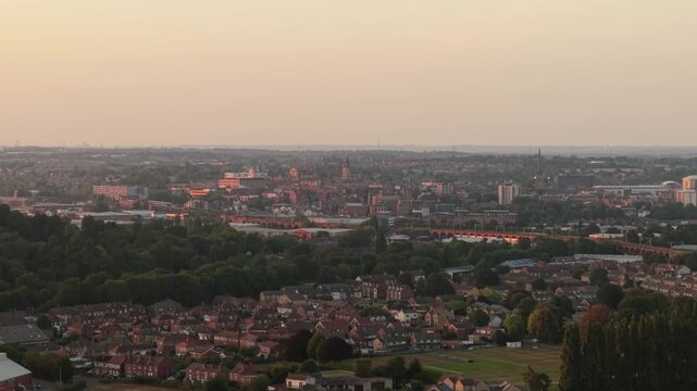 Aerial view of Wakefield, a cathedral city located on the River Calder.in West Yorkshire, England, United Kingdom. Drone POV exploration of city centre and surrounding infrastructure in sunset.