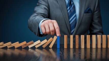 Obraz premium Business leader selecting a blue domino to stop a chain reaction and represent strategic risk
