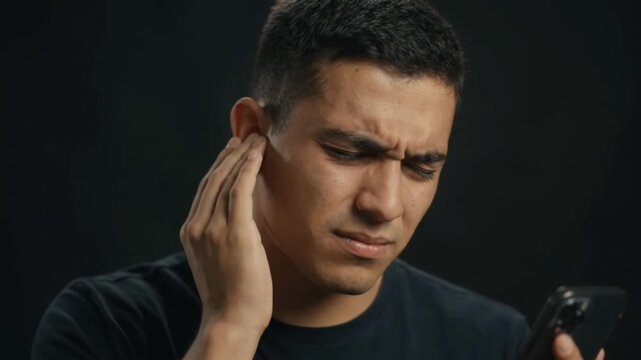 Slow Motion Man Suffering Ear Pain Holding Smartphone Single Shot