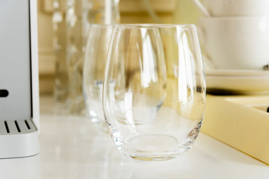 Empty glass tumbler on white kitchen counter